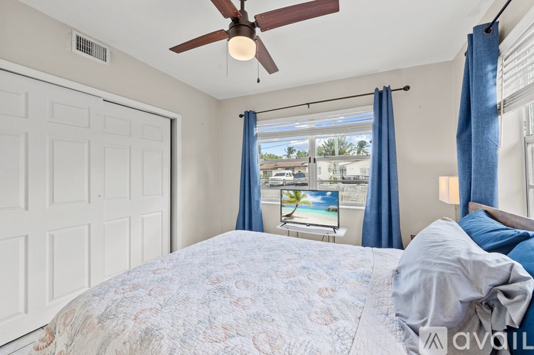 A house with a green door and two chairs outside.