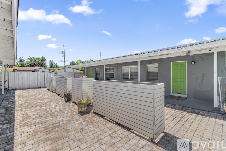 A row of houses with a green door and a sign that says "available".