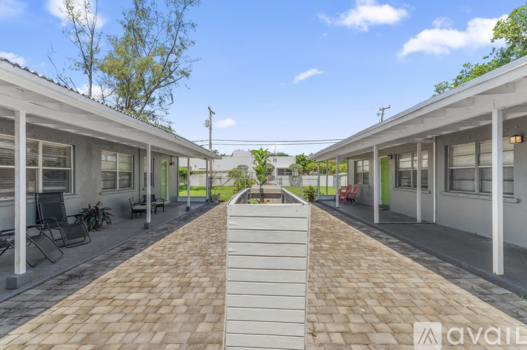 A long, narrow walkway separates two rows of houses.