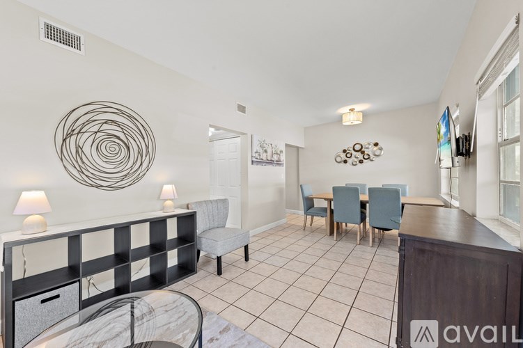 A living room with a red couch and a glass coffee table.