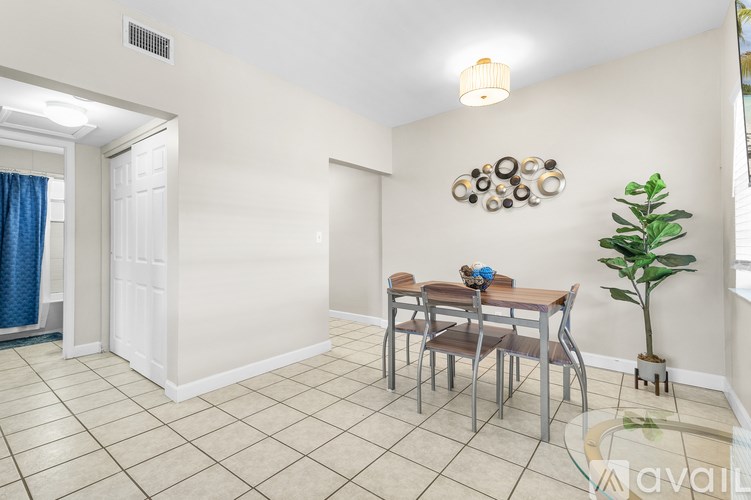 A dining room with a table and chairs.