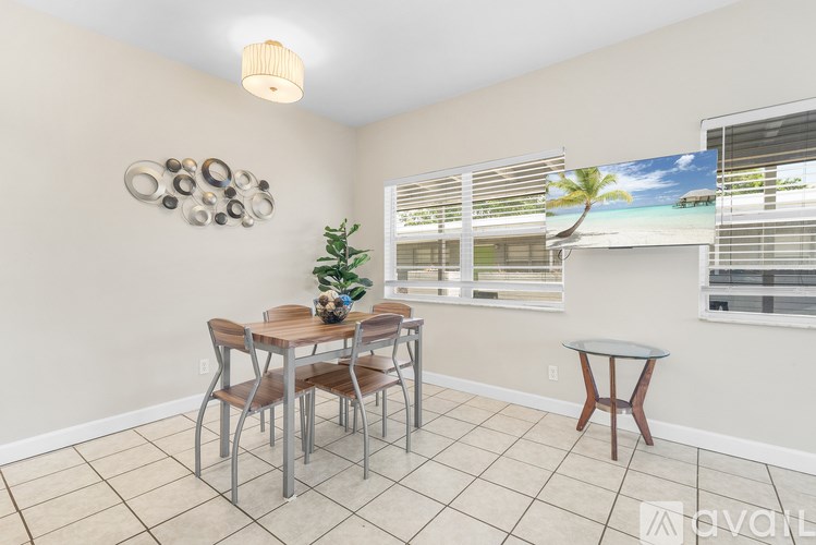 A dining room with a table and chairs.