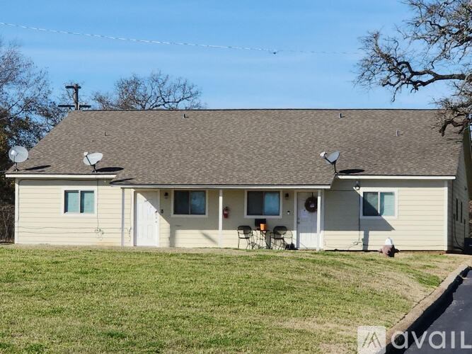 A house with a brown roof and a white door is shown.