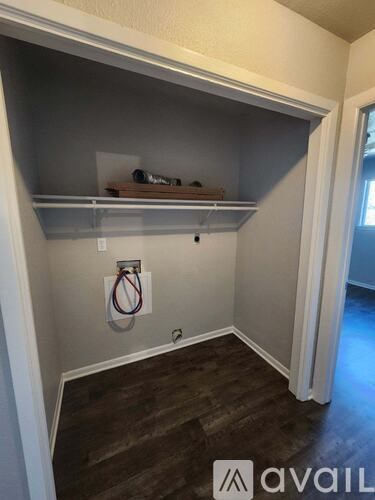 A room with a shelf and a ring light.