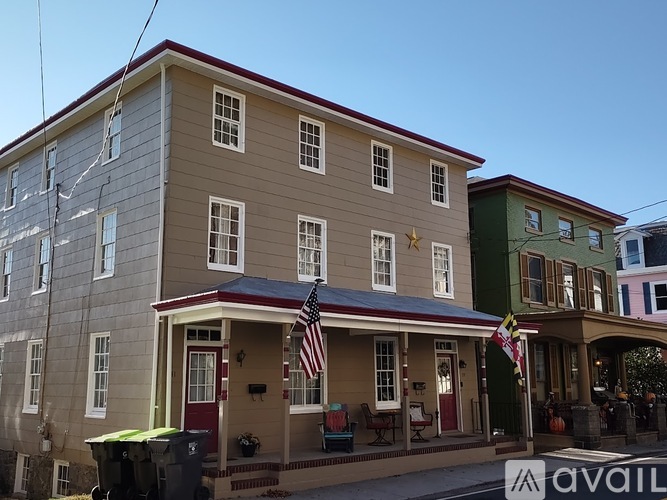 A building with a red door and an American flag on the porch.