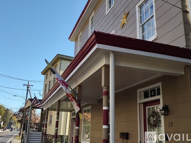 A house numbered 39 with a red awning and a yellow star on the roof.