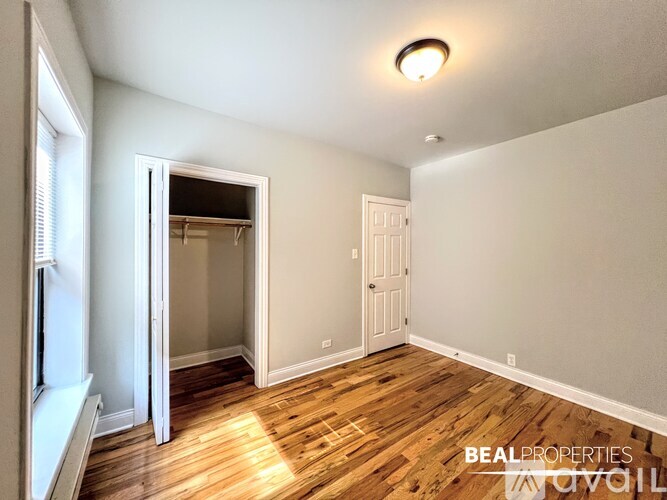 A room with wooden floors and a white door.