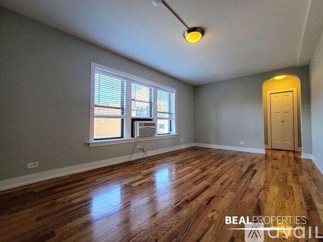 A bathroom with a toilet, tub, and a window.