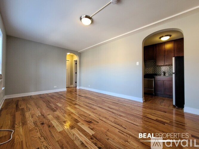 A kitchen with wooden floors and a stove top oven.