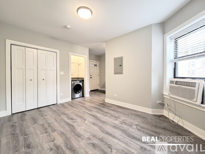 A bathroom with a white tub and a window.