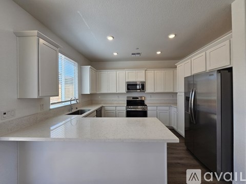A modern kitchen with white cabinets and a large island.