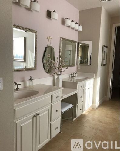 A bathroom with two sinks and a mirror above the vanity.