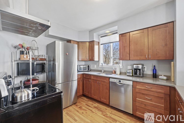 A kitchen with wooden cabinets and stainless steel appliances.