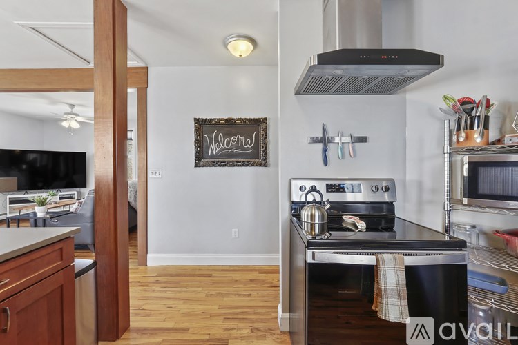 A kitchen with a stove top oven and a sign that says "Welcome".