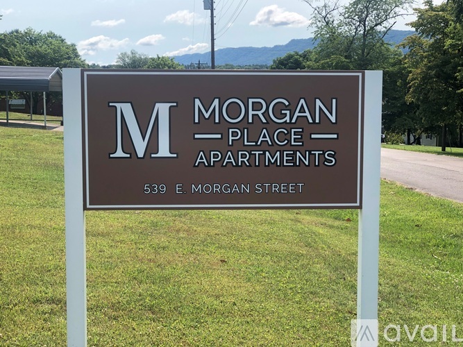 A sign for Morgan Place Apartments stands in a grassy area.
