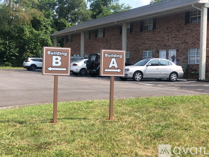 Two signs in front of a building with the letters B and A on them.