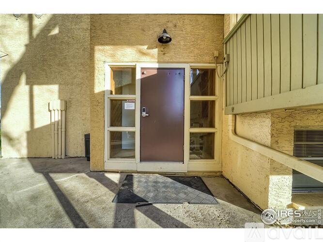 A brown door is in the center of a hallway.