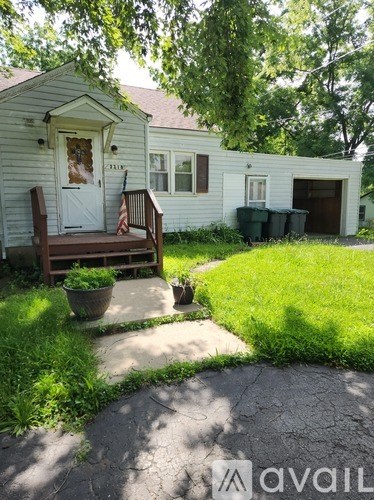 A house with a white door and a flag on the porch.