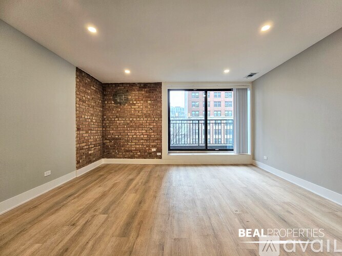 A living room with a white couch, a coffee table, and a brick wall.