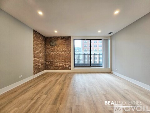 A living room with a white couch, a coffee table, and a brick wall.