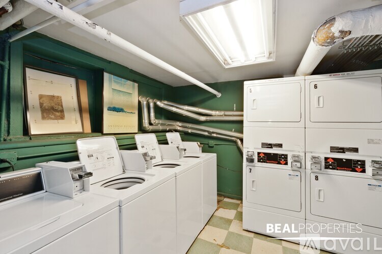 A laundry room with washers and dryers.