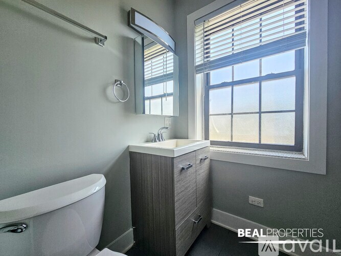 A room with a ceiling fan and two windows.