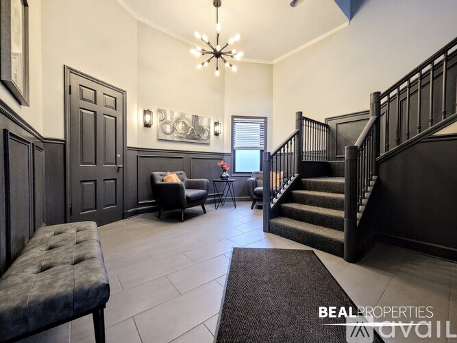 A foyer with a staircase and a bench.