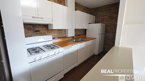 A kitchen with white appliances and wooden countertops.