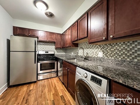 A kitchen with wooden cabinets and a checkered backsplash.