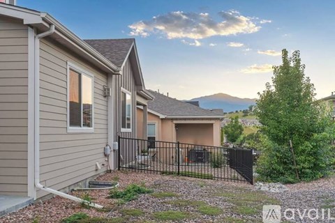 A house with a mountain in the background is for sale.
