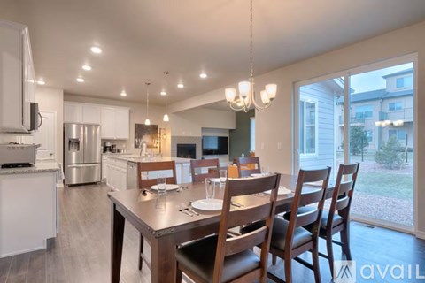 A modern kitchen with a dining table set for four.