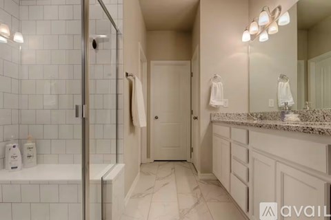 A bathroom with a marble floor and white walls.