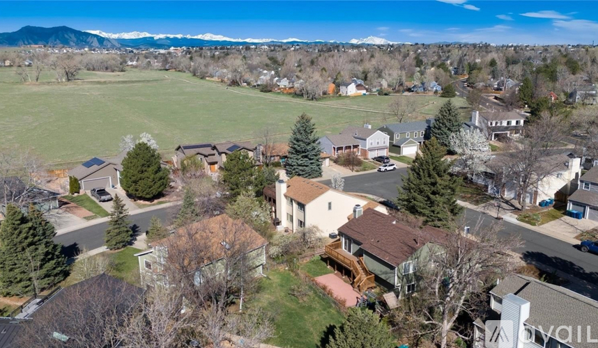 A bird's eye view of a residential neighborhood with houses and trees.