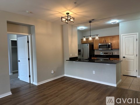 A kitchen with a refrigerator, microwave, and oven is available for rent.