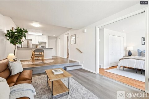 A living room with a brown leather couch and a wooden coffee table.