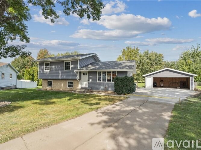A two-story house with a garage is situated in a residential area.