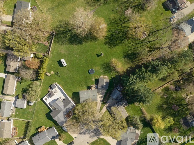 A bird's eye view of a neighborhood with houses and trees.