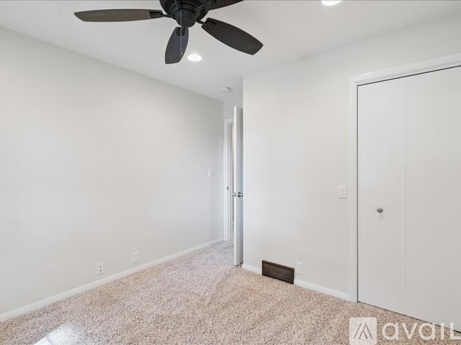 A living room with a grey sofa and a wooden floor.