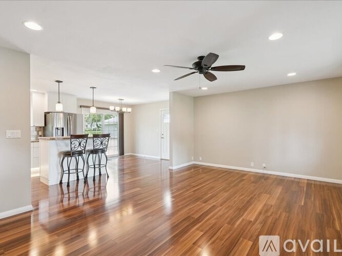 A patio with a table and chairs and a sun umbrella.