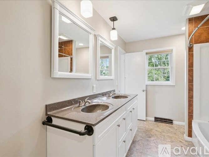 A bathroom with a toilet, sink, and shower.
