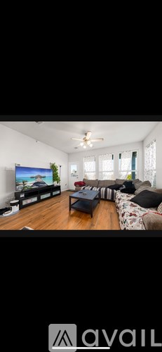 A living room with a television and a couch.