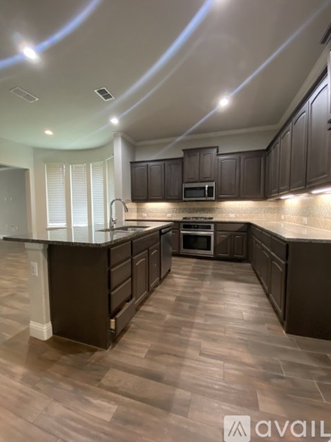 A kitchen with dark wood cabinets and a countertop.
