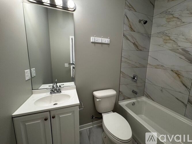 A bathroom with a sink, toilet, and bathtub.