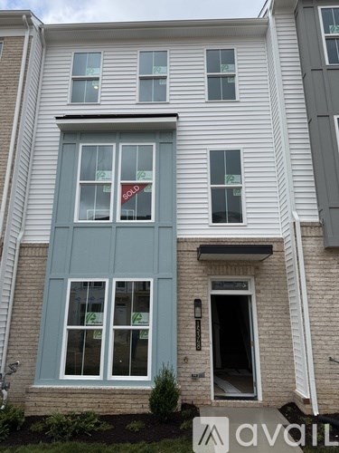 A house with a "Sold" sign in the window.