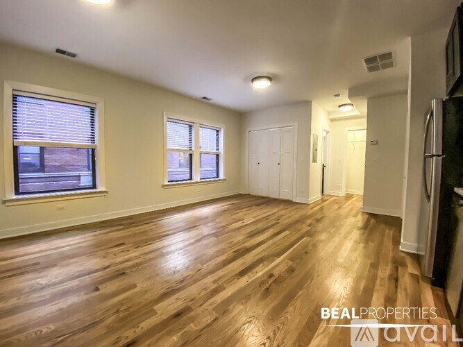 A kitchen with wooden floors and black cabinets is available for rent.
