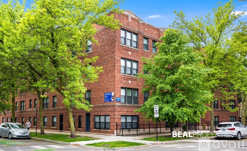 A red brick building with trees in front of it.