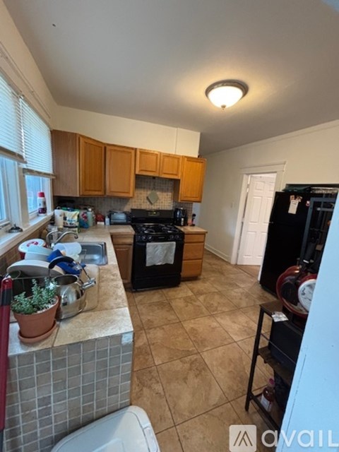A kitchen with a black oven and black fridge.