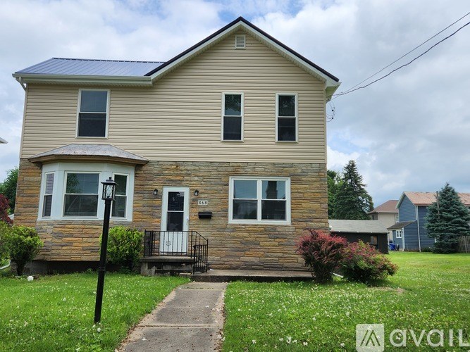 A house with a front porch and a small front yard.