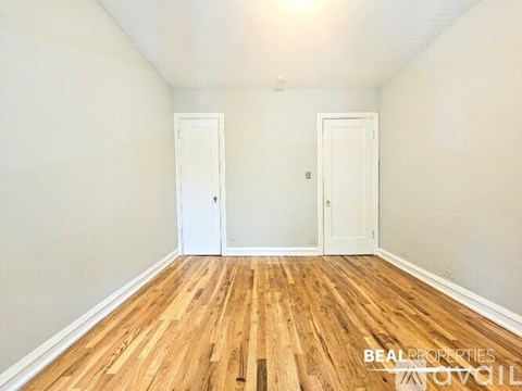 A kitchen with a white stove and wooden cabinets.