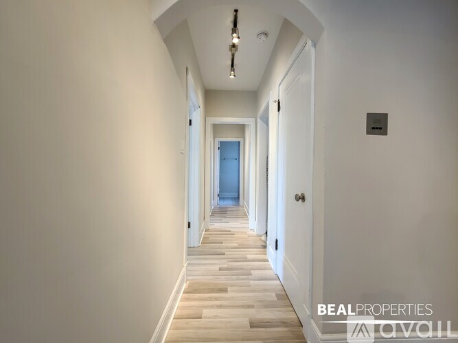 A long hallway with a door at the end.